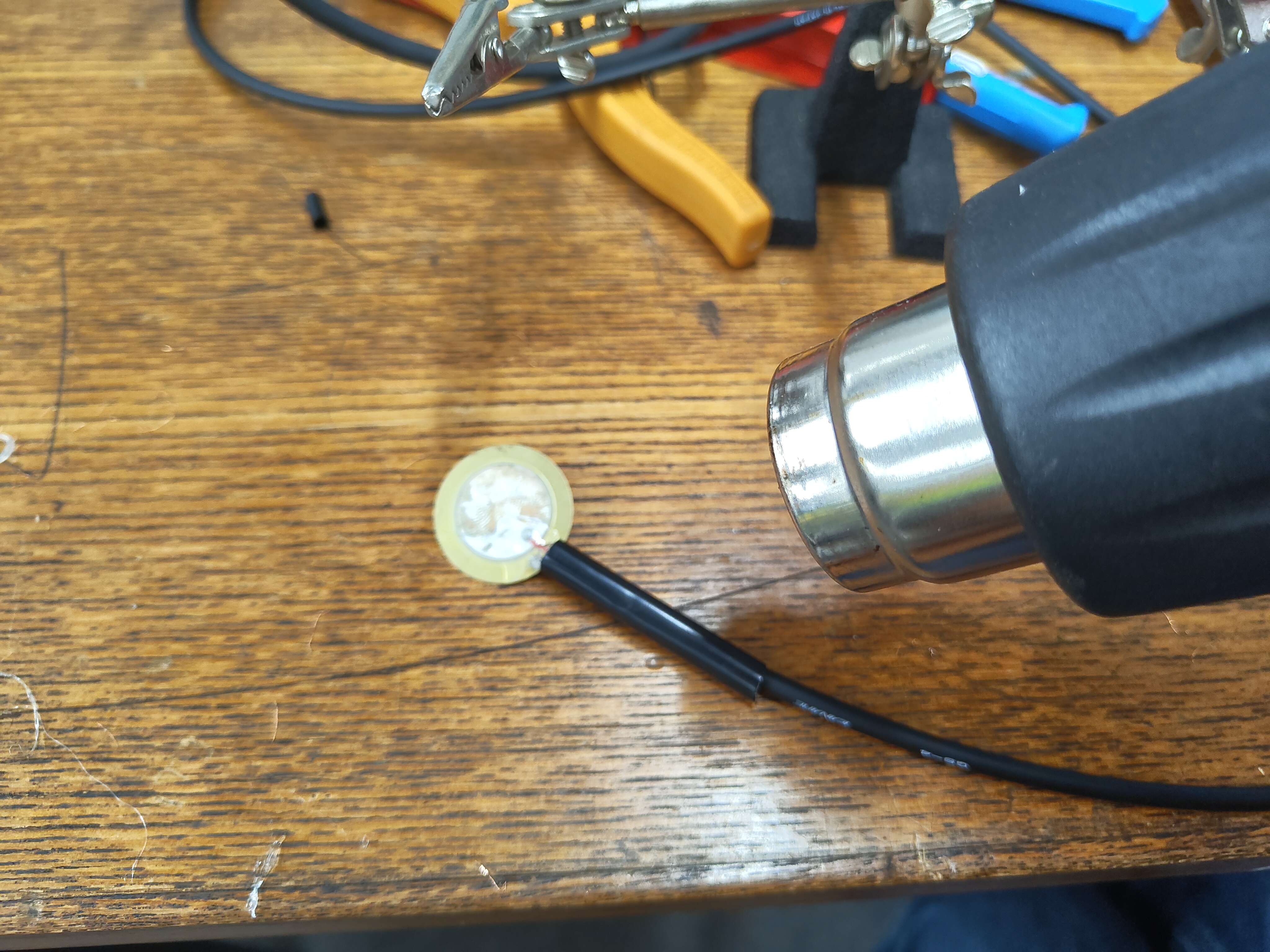 Image of applying heat gun to shrink tube